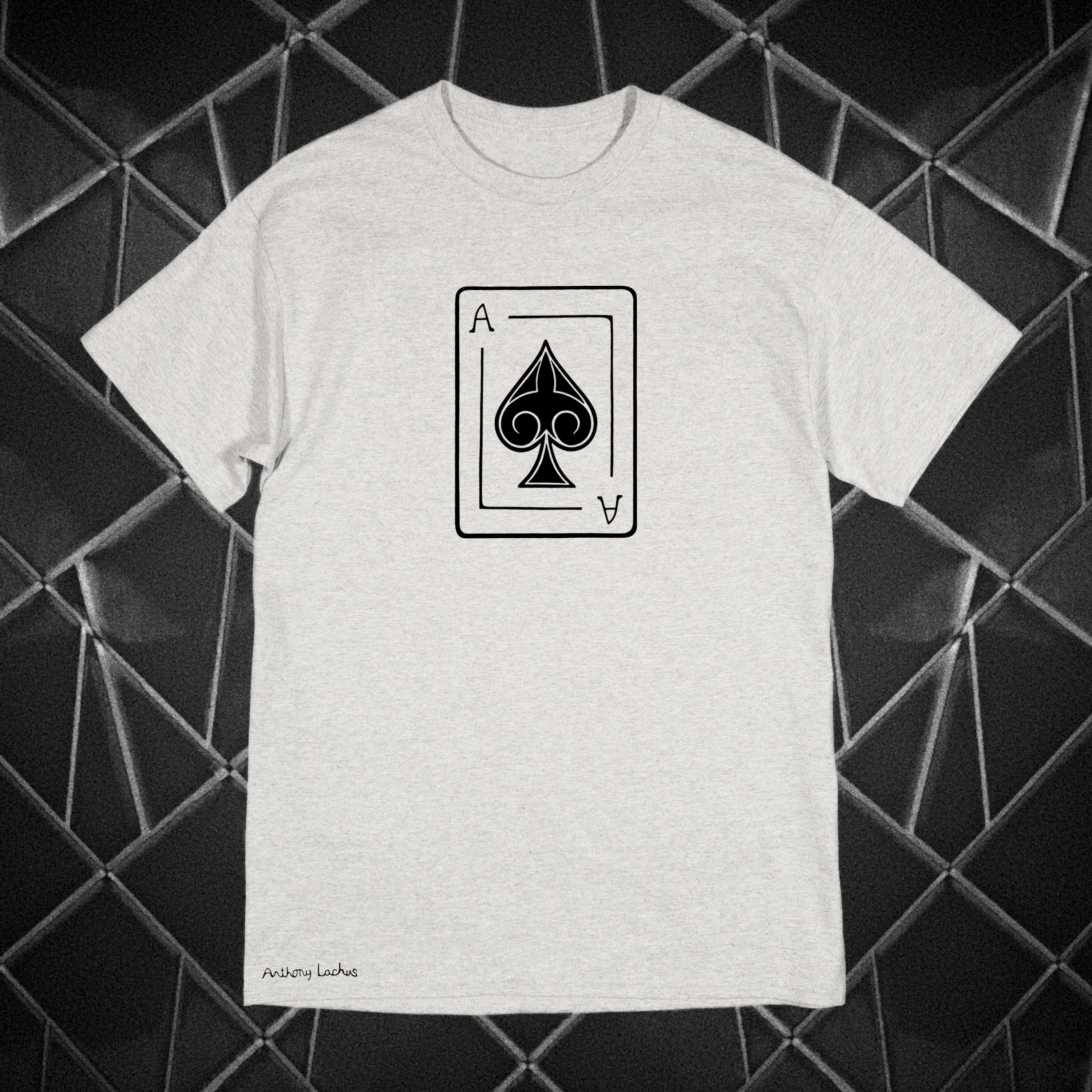 Gray t-shirt with a black playing card spade symbol on a geometric black and gray background