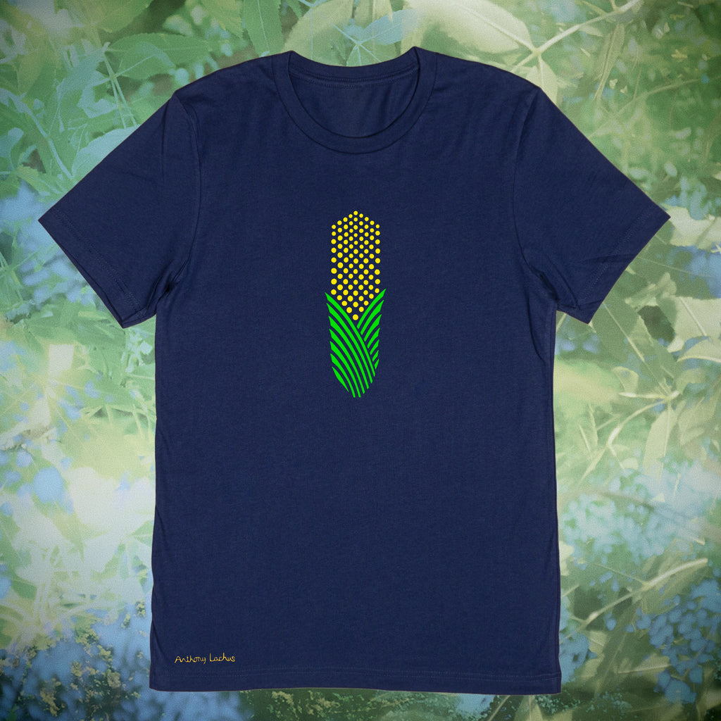 A navy blue short-sleeve t-shirt with a central graphic of a green and yellow corn cob, displayed against a blurred green foliage background.