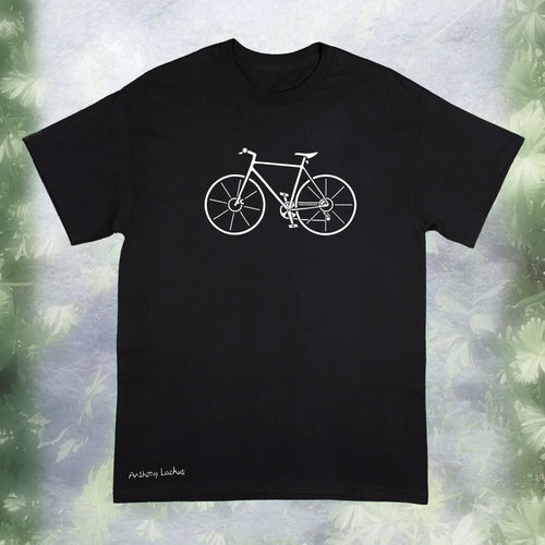 A black Gildan g500 t-shirt featuring a graphic design of a white bicycle, laid flat on a white and green background. An original, hand drawn design by Anthony Lachus with the artists signature on the lower left. Front view.