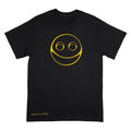 A black short-sleeve crewneck t-shirt featuring a yellow minimalist smiley face graphic on the chest and a small yellow 'Anthony Lachus' signature on the bottom left hem, shown against a plain white background.