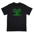 A black short-sleeve crewneck t-shirt with a green line art graphic of a tree with roots on the chest, and a small green signature reading 'Anthony Lachus' near the bottom left hem, displayed against a light background. An original, hand drawn artwork by Anthony Lachus. Front view.