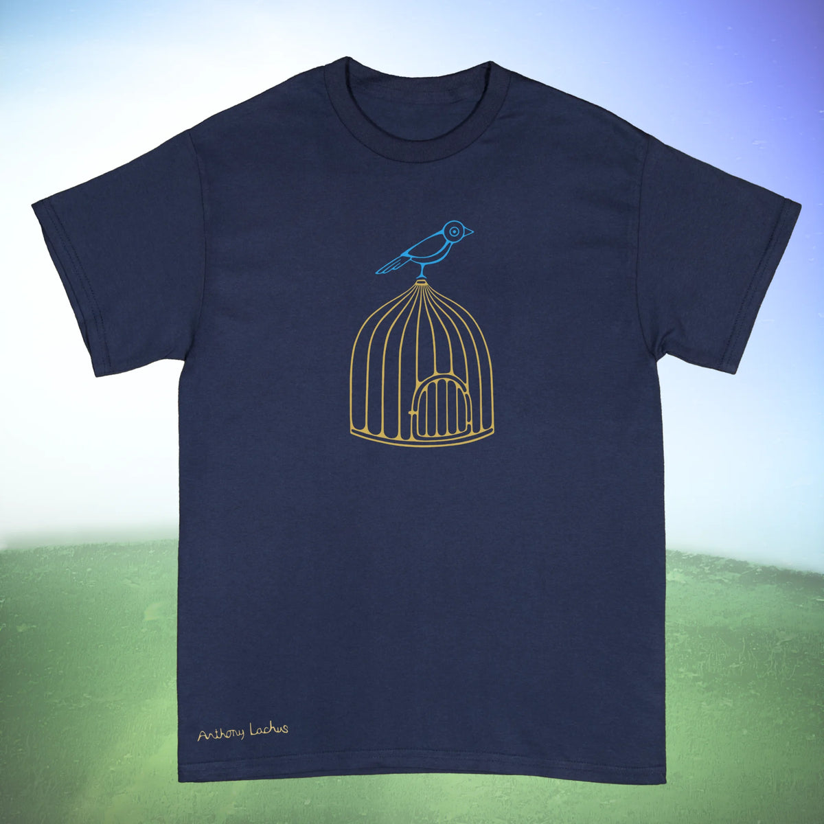 A navy blue short sleeved Gildan g500 crewneck t-shirt featuring a graphic design of a blue bird perched on golden cage, laid flat on a green and white background. Original hand drawn artwork by Anthony Lachus. Front view.