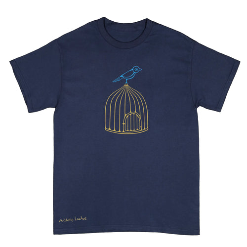 A navy blue short-sleeve crewneck t-shirt featuring a graphic of a blue bird perched on a gold wire birdcage. The name 'Anthony Lachus' is printed in a small gold script near the bottom left corner. An original, hand drawn artwork by Anthony Lachus.