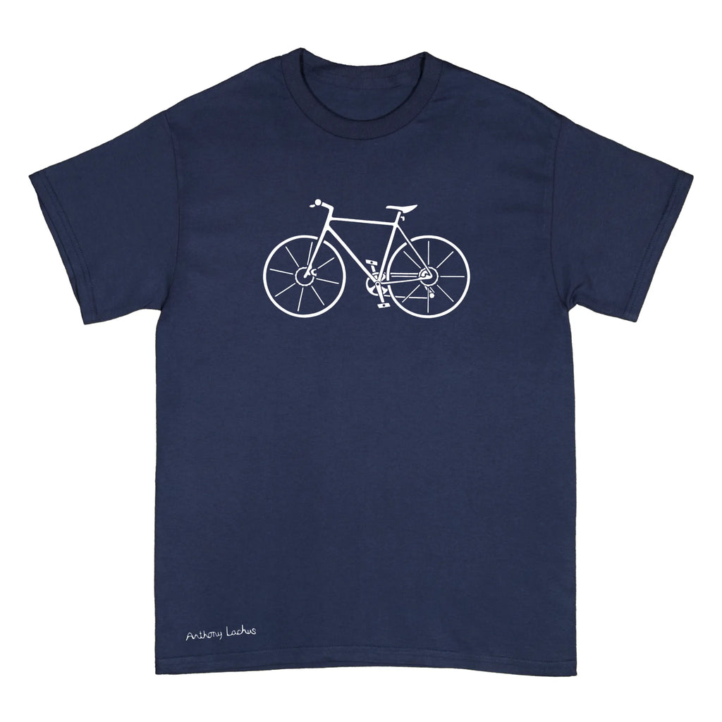 A navy blue short-sleeve crewneck t-shirt featuring a white line art graphic of a bicycle on the chest and the text 'Anthony Lachus' printed near the bottom left hem, shown against a plain white background. An original, hand drawn artwork by Anthony Lachus. Front view.