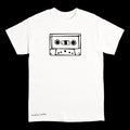 A white short-sleeve crewneck t-shirt featuring a black line art graphic of a cassette tape on the chest and the text 'Anthony Lachus' printed near the bottom left, displayed against a solid black background.
