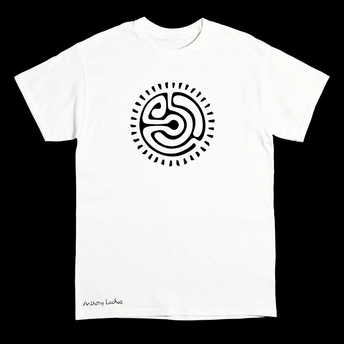 A white short-sleeve crewneck t-shirt with a black circular abstract symbol printed on the chest and small black text that says ‘Anthony Lachus’ near the bottom left hem, displayed against a solid black background.