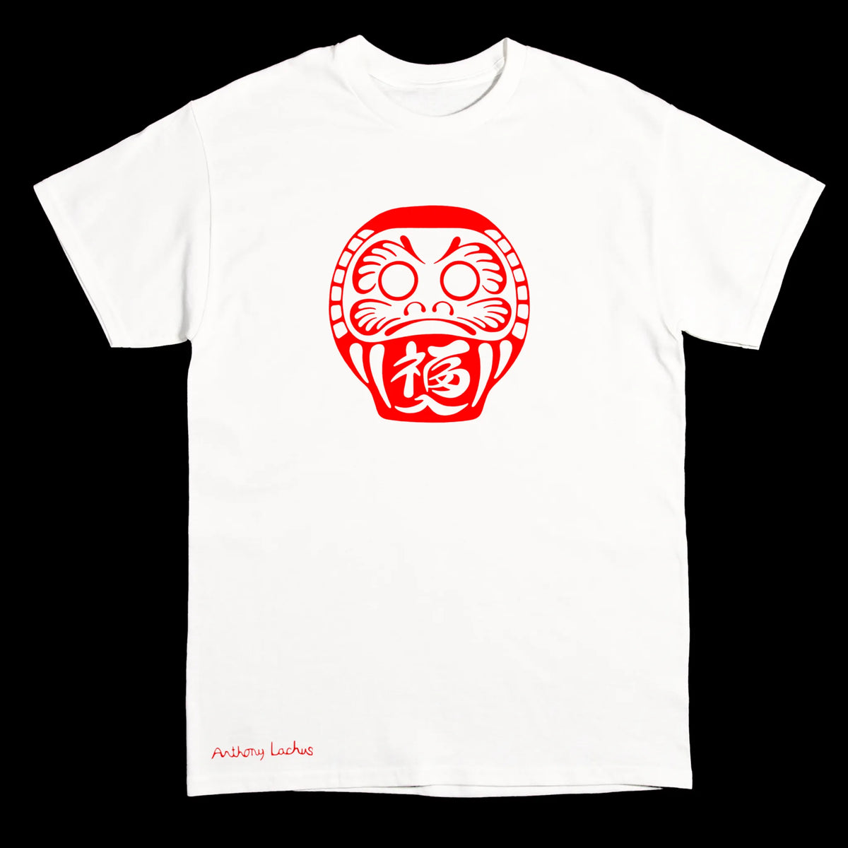 A white short-sleeve crewneck t-shirt featuring a red Daruma doll graphic on the chest and 'Anthony Lachus' printed in red near the bottom left hem, shown against a solid black background.